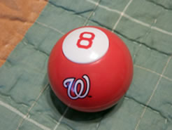 A red 8 ball, with curly white W logo on the side