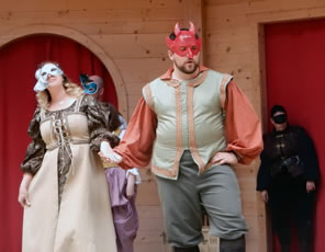 Photo of Beatrice and Benedick dancing in masks