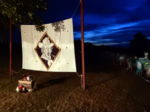 Photo of banner with Shakespeare at Winedale logo with sunset behind