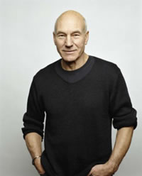 Patrick Stewart, dark sweater shirt with long sleeves rolled up to elbows